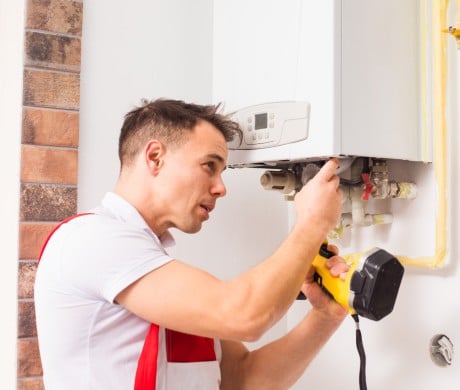 Plumber servicing a boiler in Stevenage